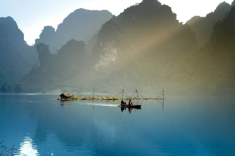 a couple of small boats floating on top of a lake