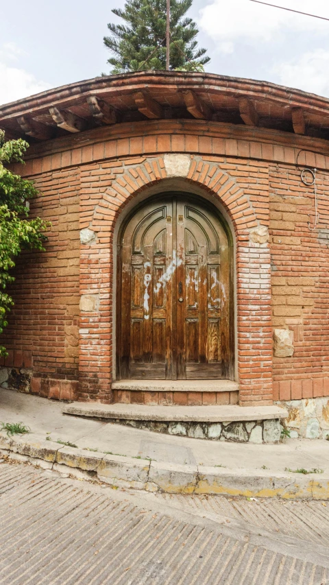 an arched doorway surrounded by brick walls and stone steps