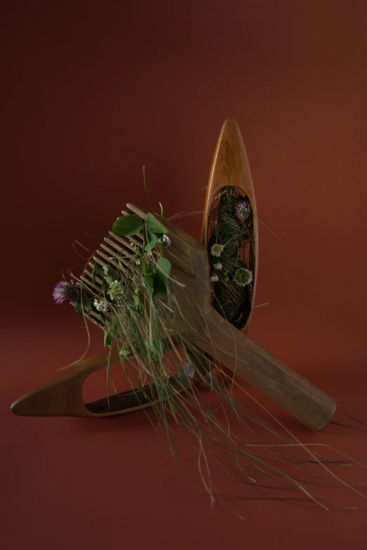 a hand made object with flowers and grasses