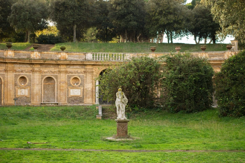 a statue sitting in the middle of a park area