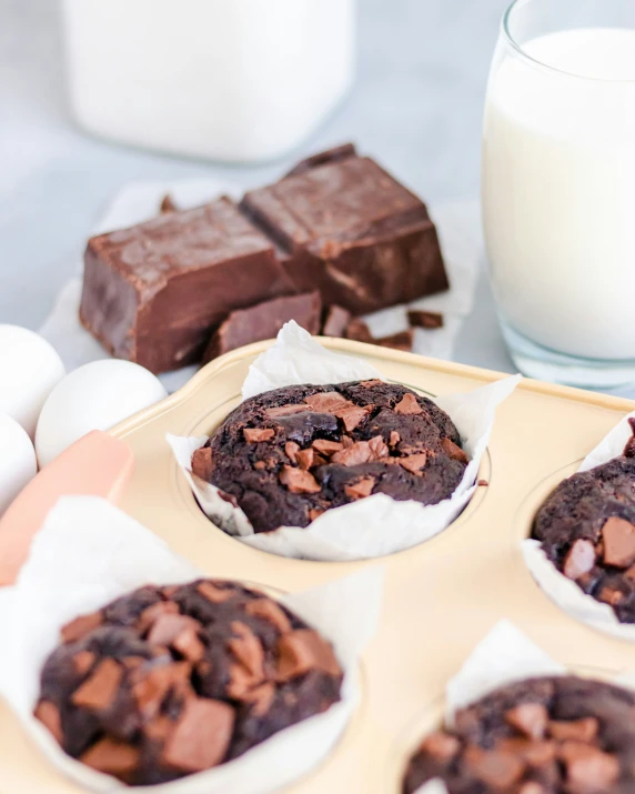 chocolate cookies with some milk next to them