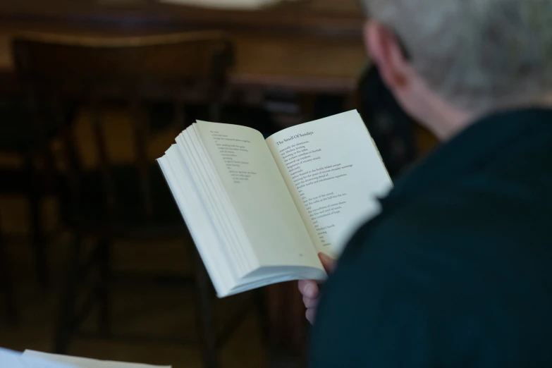 a person holding a book up to the camera