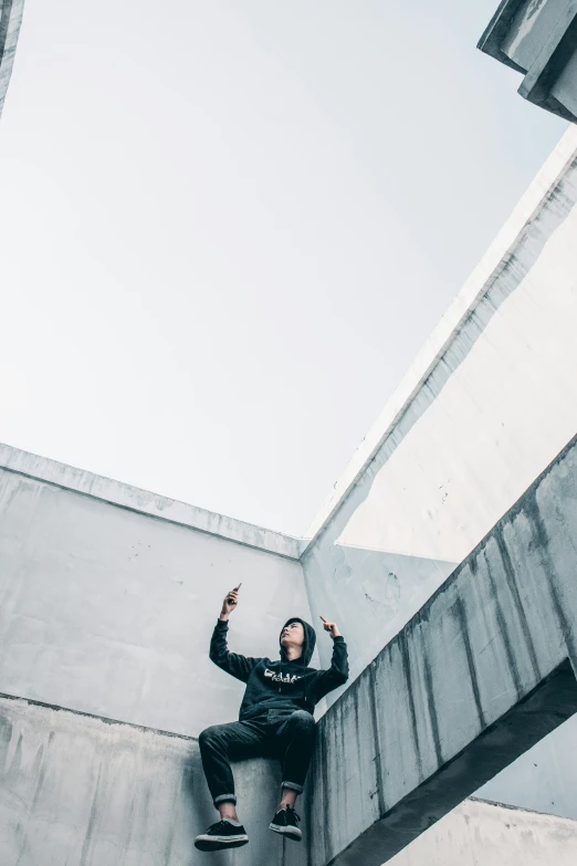 a man riding a skateboard up the side of a stone wall