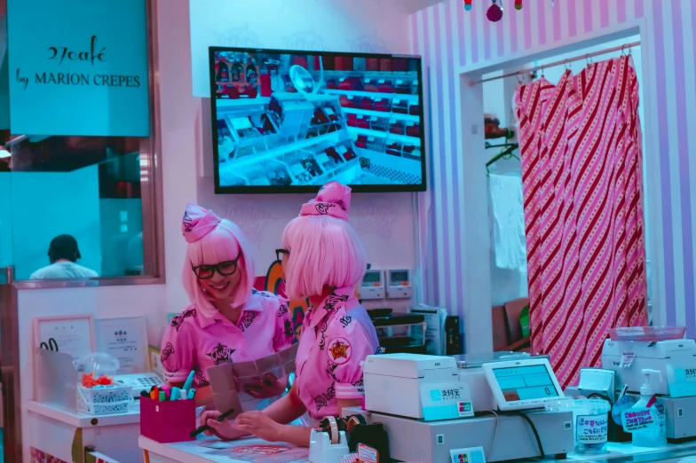 a woman and child in pink costumes at a sewing machine