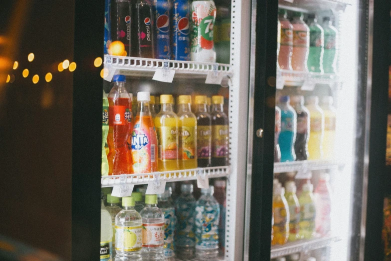 an image of cold beverages in refrigerators at night