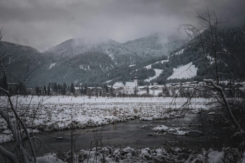 an image of a snow covered mountain scene with a small stream