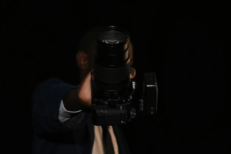 a person holding up a camera to take a po