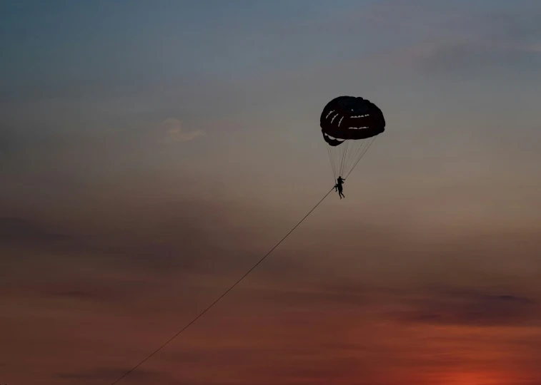 someone with a parachute high up in the sky