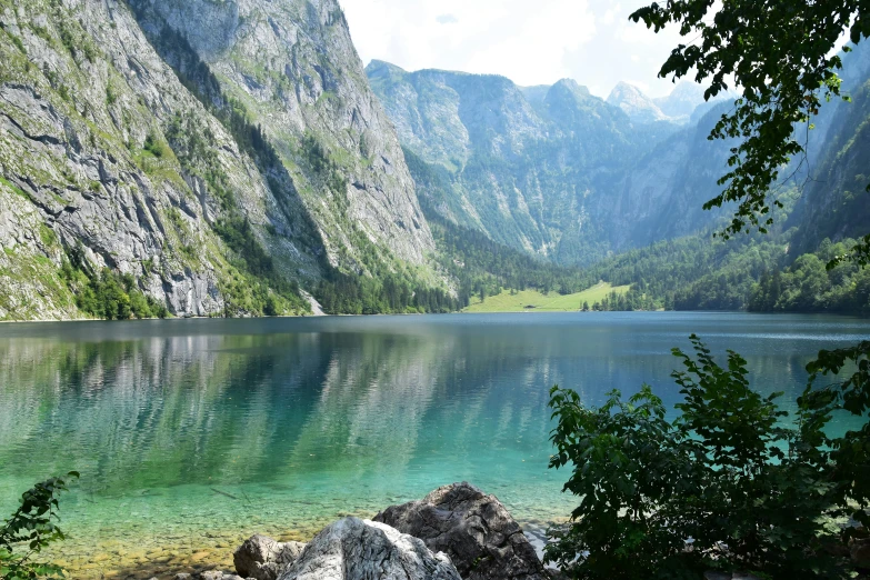 a body of water surrounded by mountains and trees