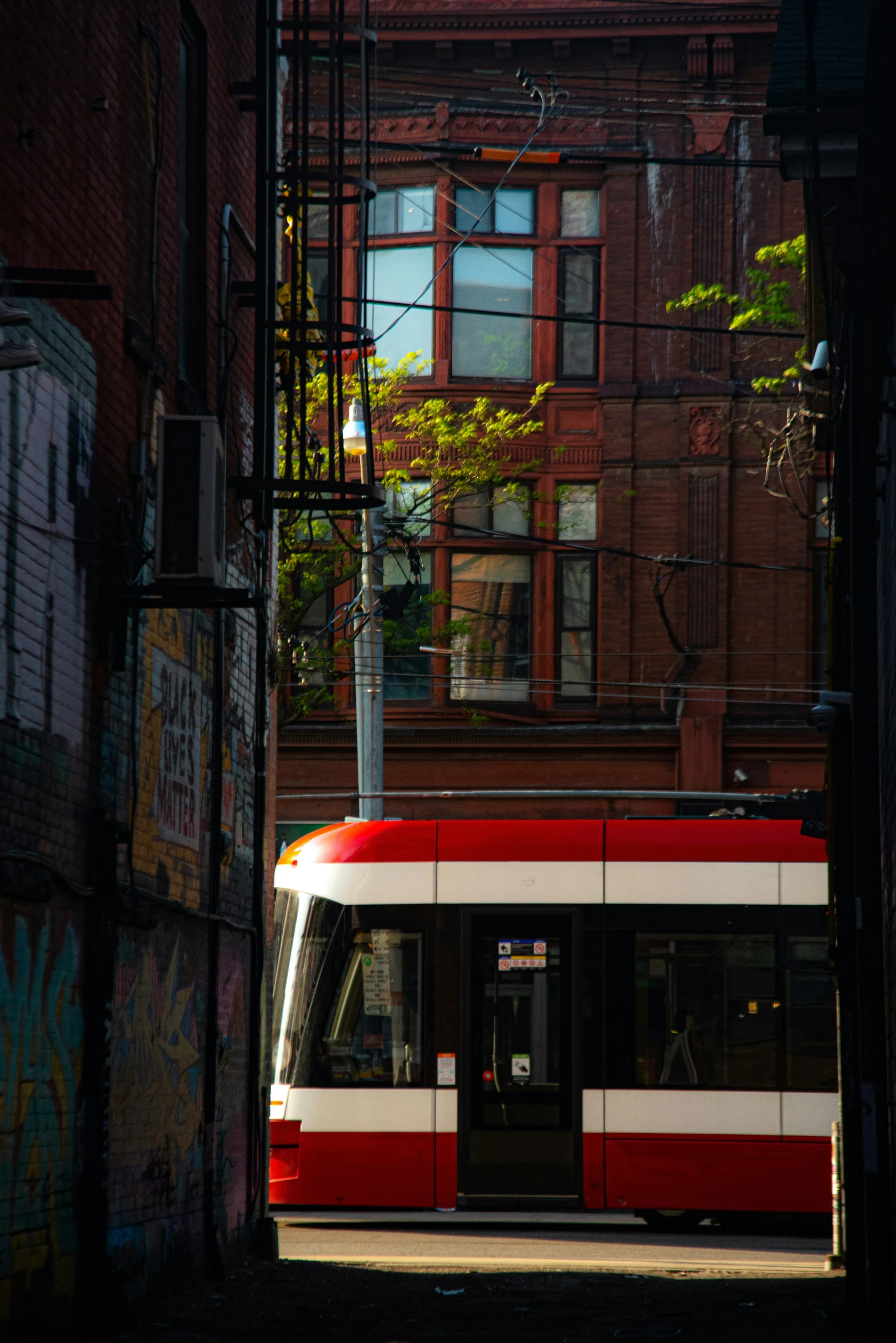 a street scene with a tram going down the road