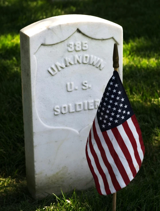 a american flag that has been placed in front of a marker