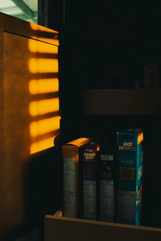 a number of boxes near a light on a shelf