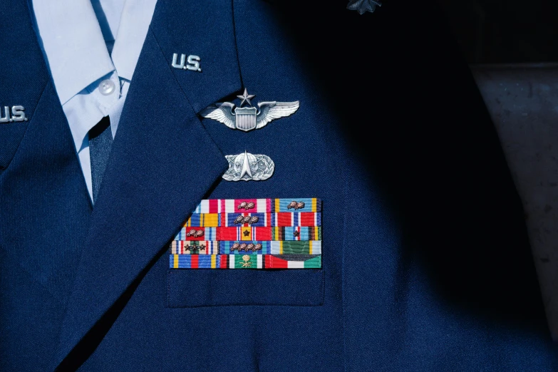 a closeup of a blue suit with patches on it