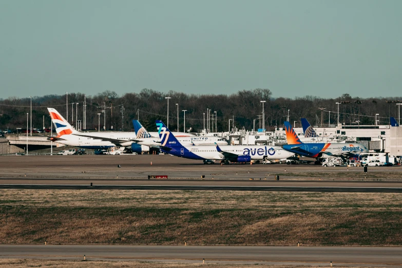 the planes are parked next to each other at the airport