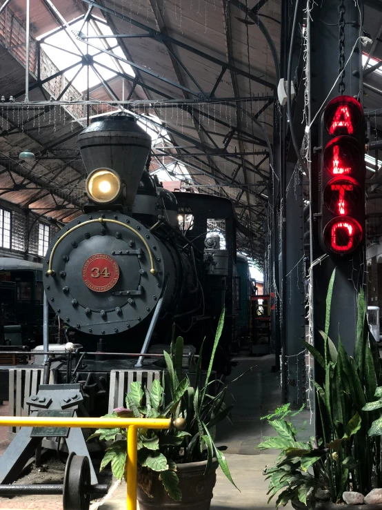 a locomotive car is parked under a hanger