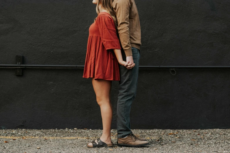 the man and woman are standing close together