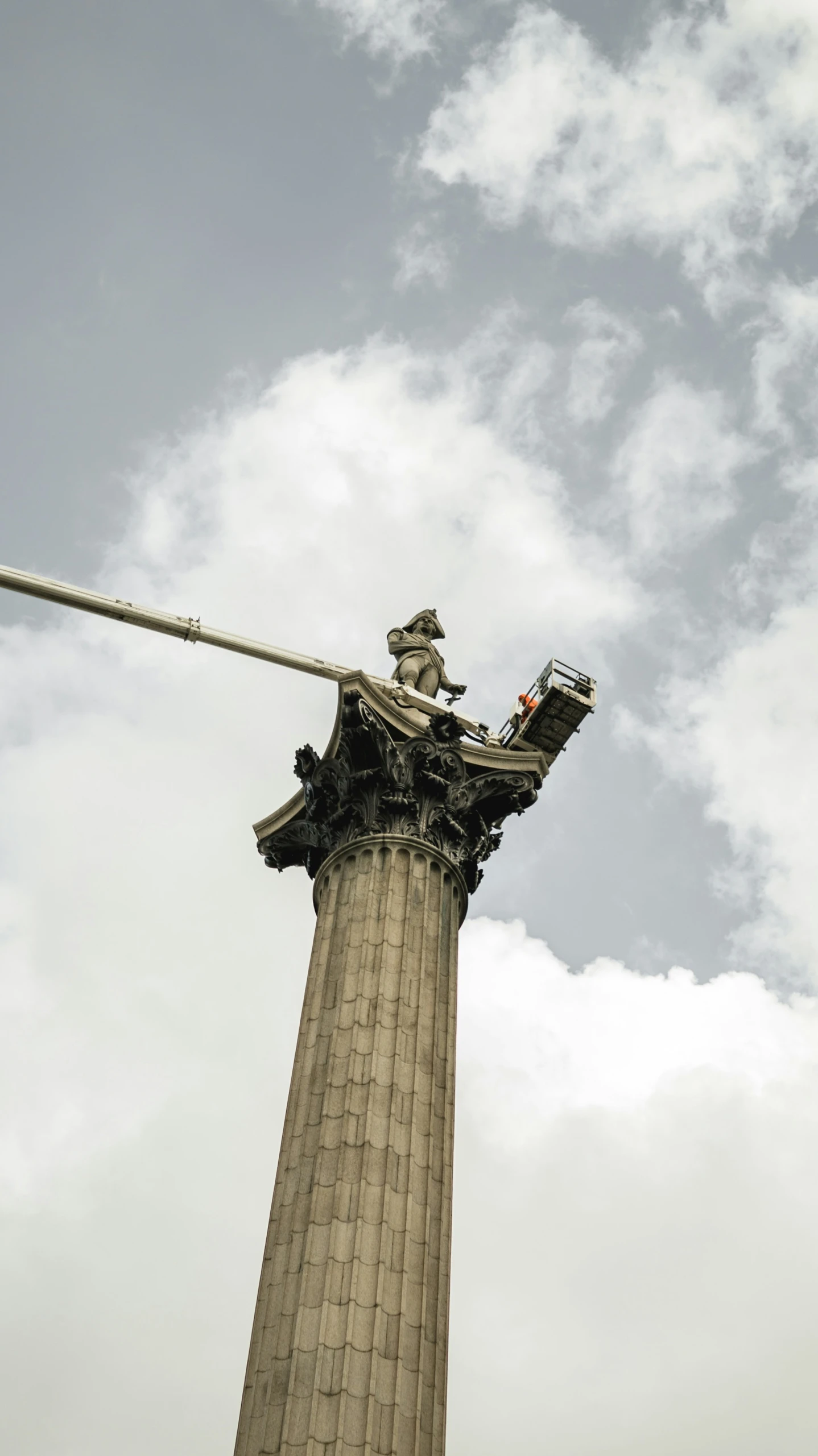 a tall stone tower with a big pipe on top