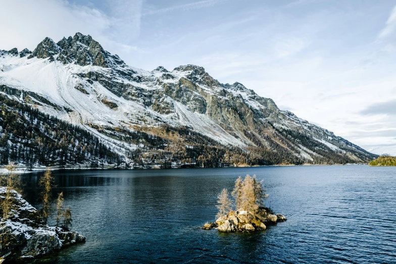 a beautiful alpine landscape with a snow covered mountain