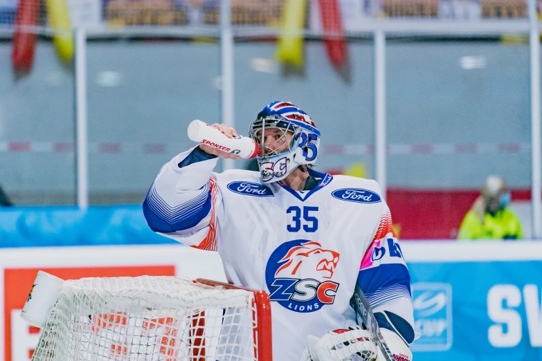 a hockey player holds his head and looks at soing