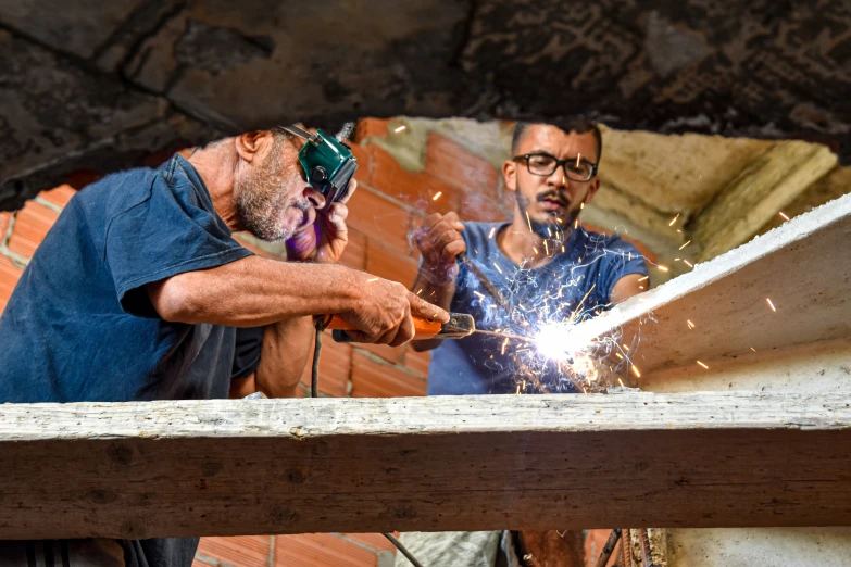 a man welderging metal in an outdoor area