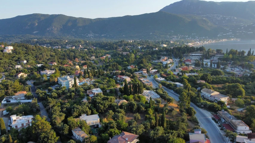 an aerial view of a town near some trees