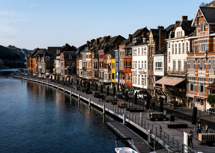 an urban area next to the water is lined with buildings and lots of people