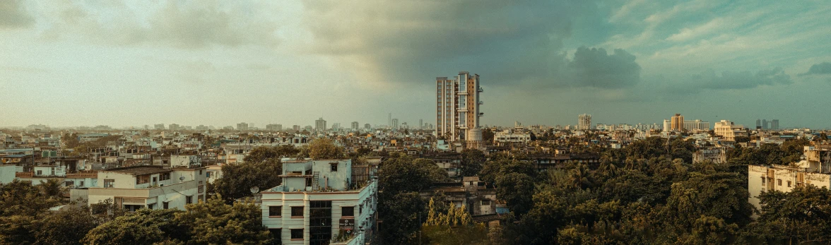 a city filled with lots of tall buildings under a stormy sky