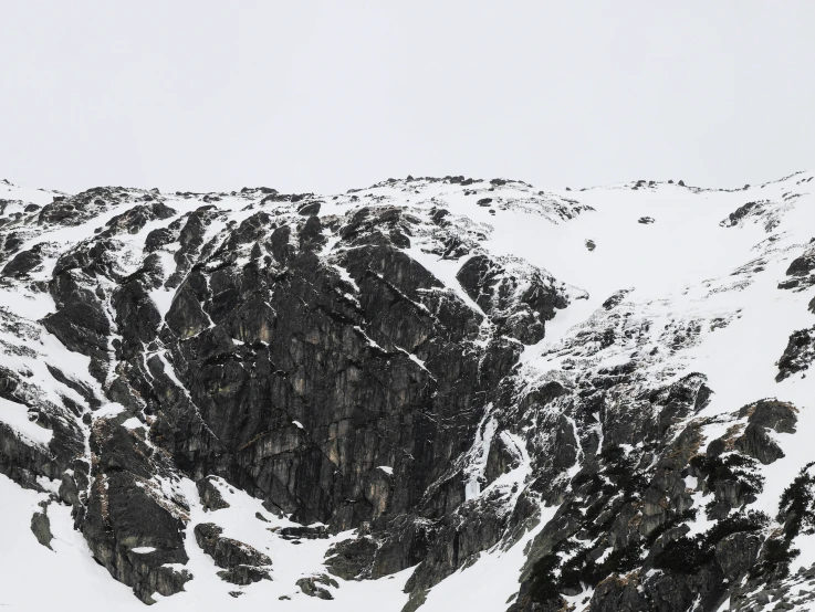 a very tall rock type structure in the middle of a mountain