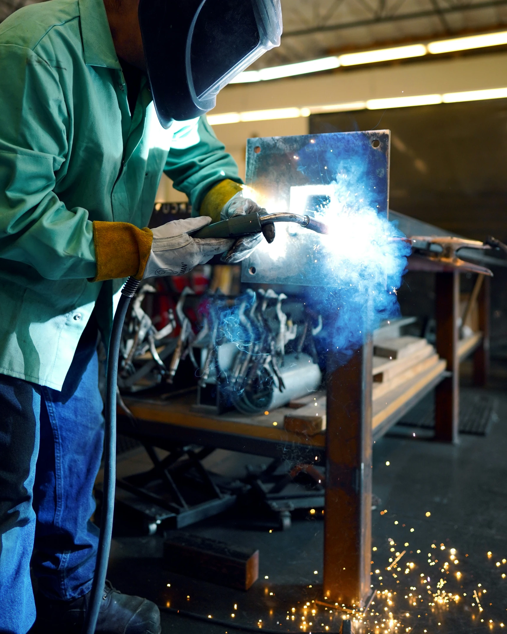 welder welding metal with a flame lighter