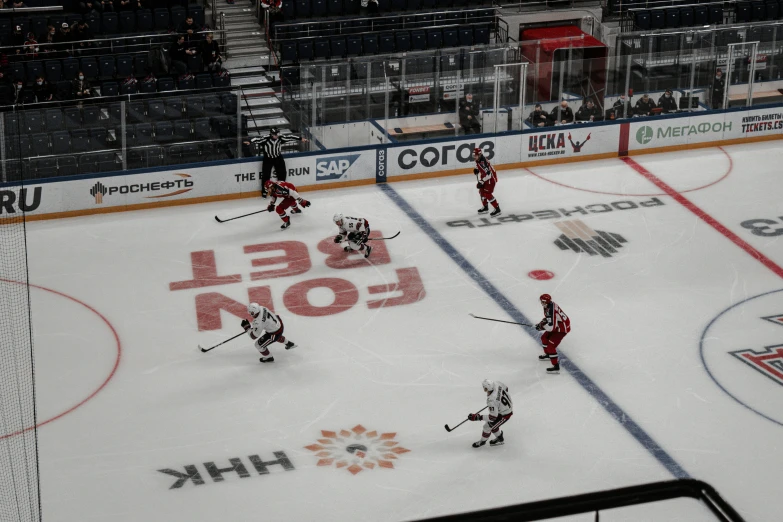 a hockey game on a big ice rink