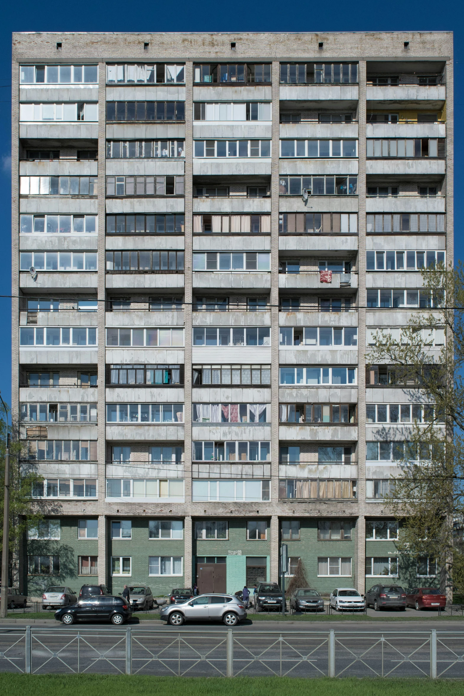 two cars are parked next to a large building