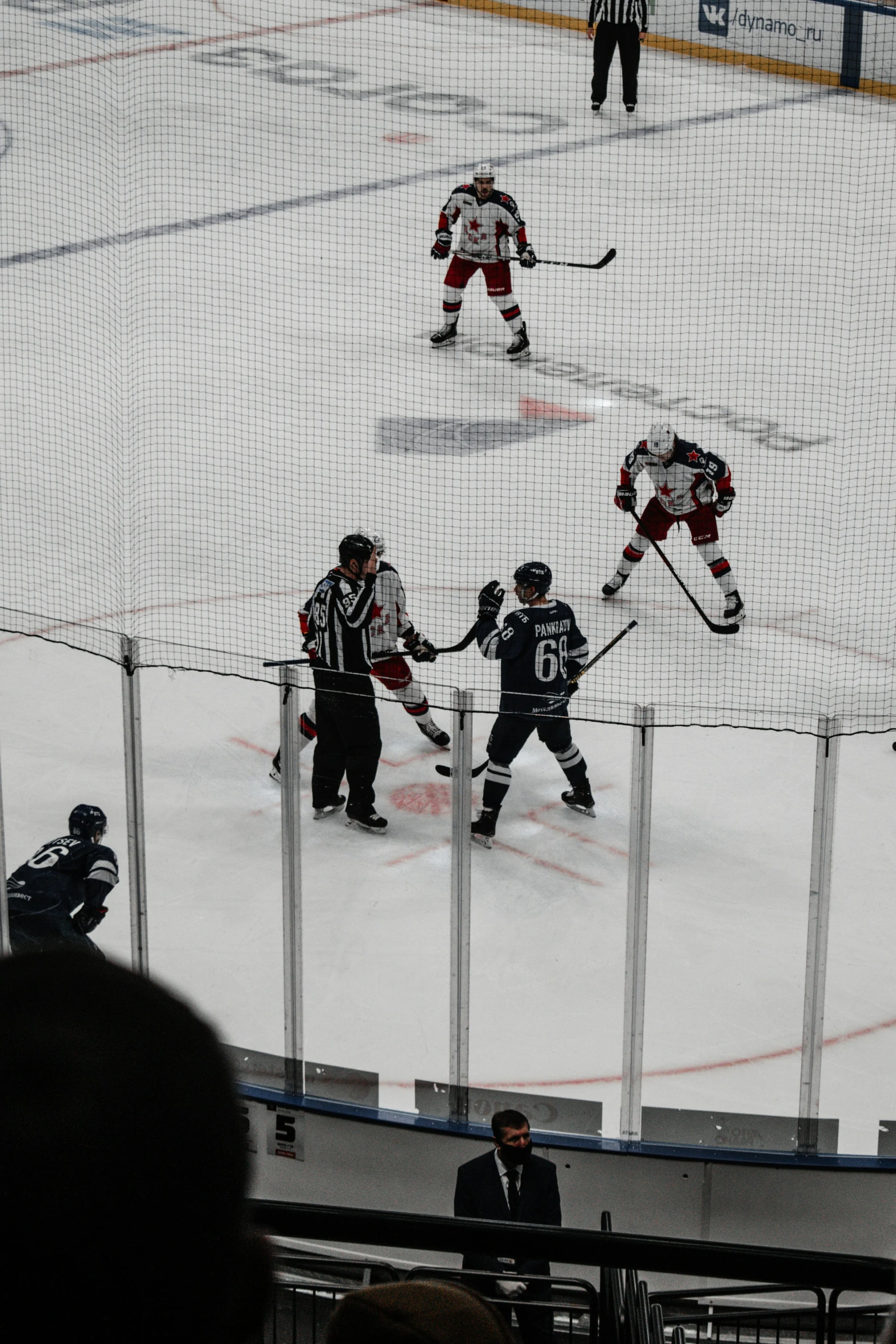 a hockey game going on with players walking across the ice