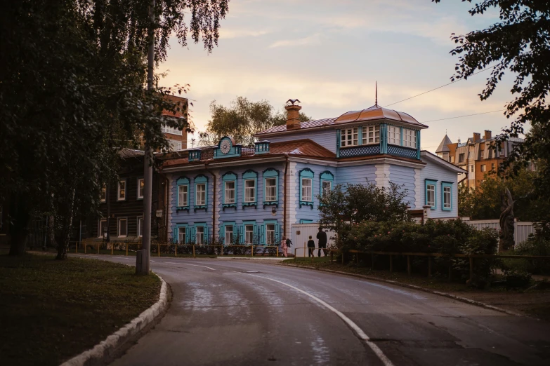 an old house along a country road in the evening sun