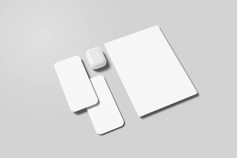 the surface of white objects including two square plates and a mouse