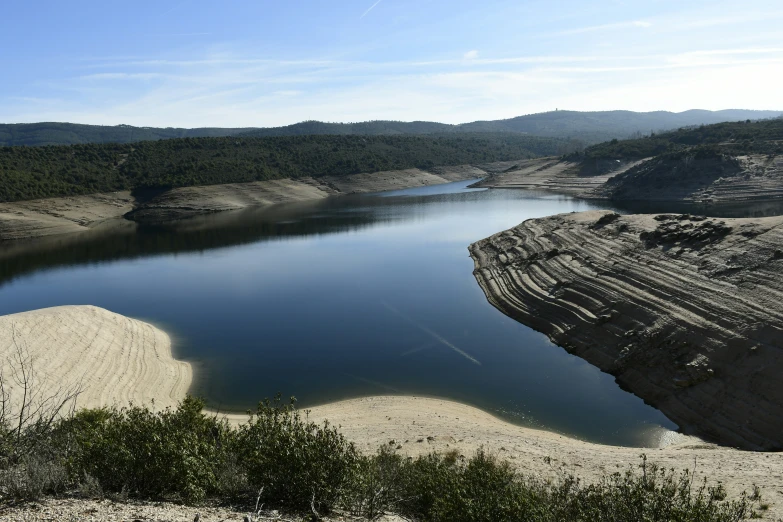 a body of water near a desert like area