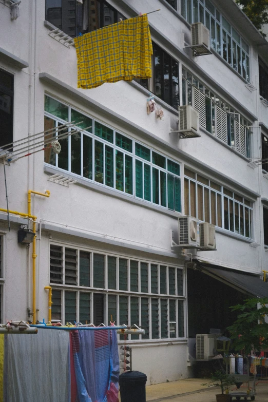 the windows and balconies on this building are covered with cloths