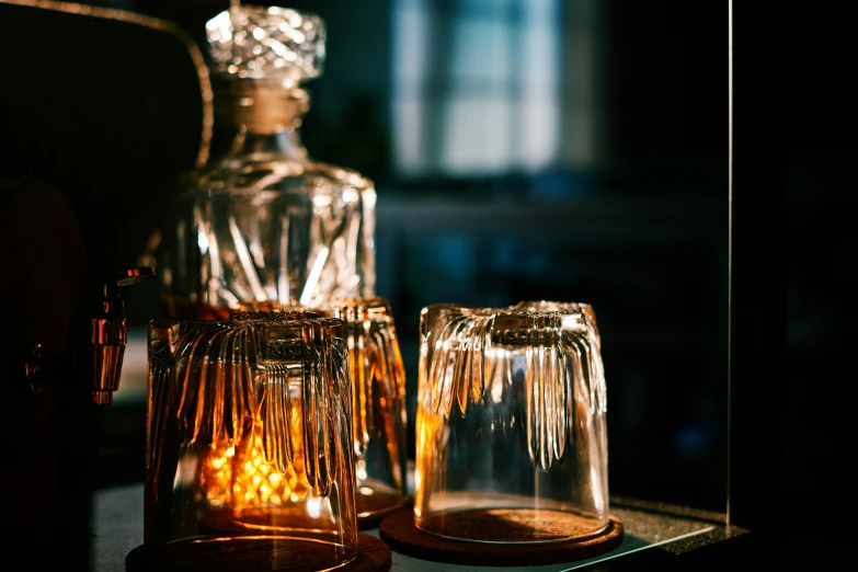 a small glass vase next to two candles