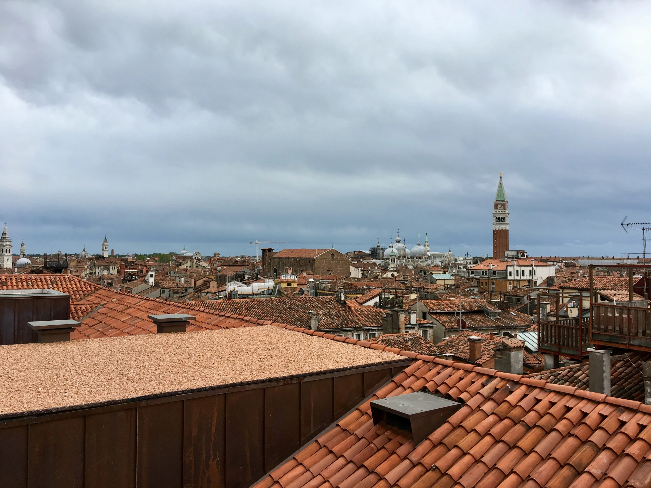 rooftops and houses with a clock tower in the background