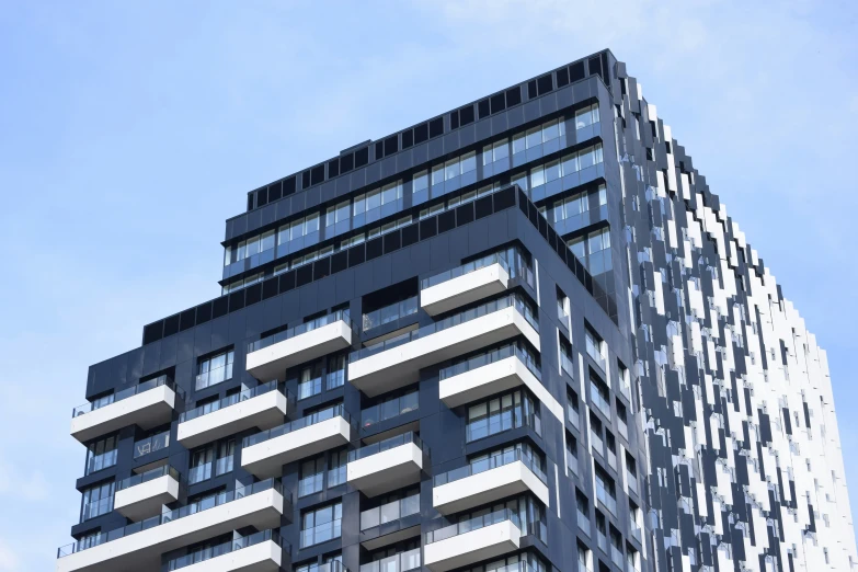 a tall building with many windows and balconies on the top of it