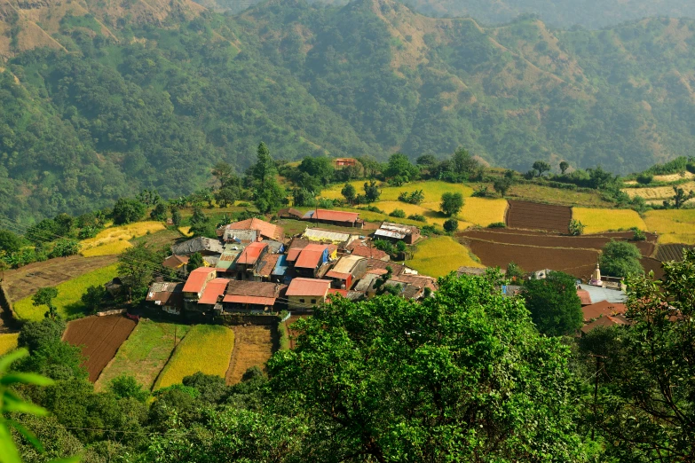 aerial view of village from above, with hills in the background