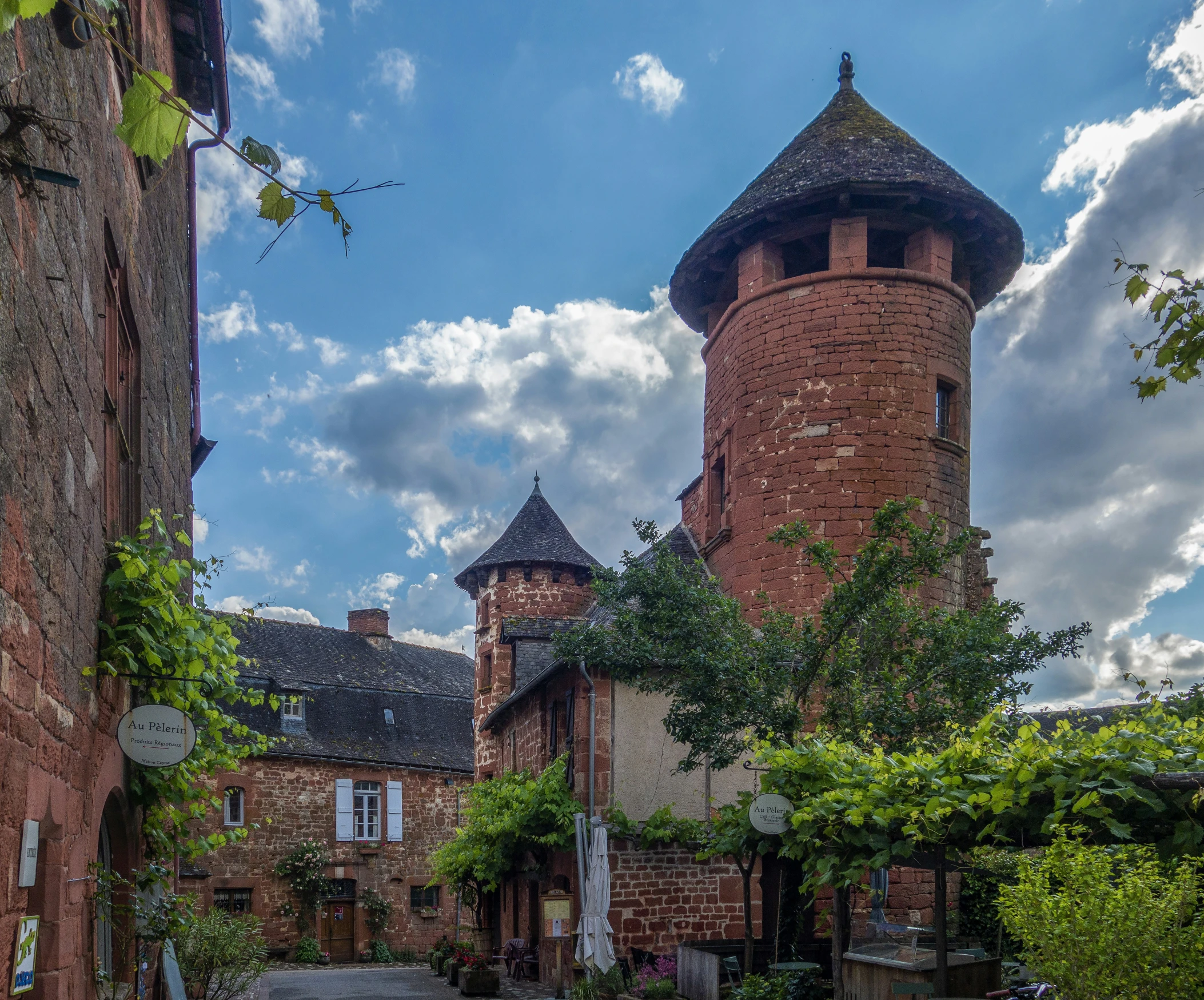 a brick building with a tower has windows