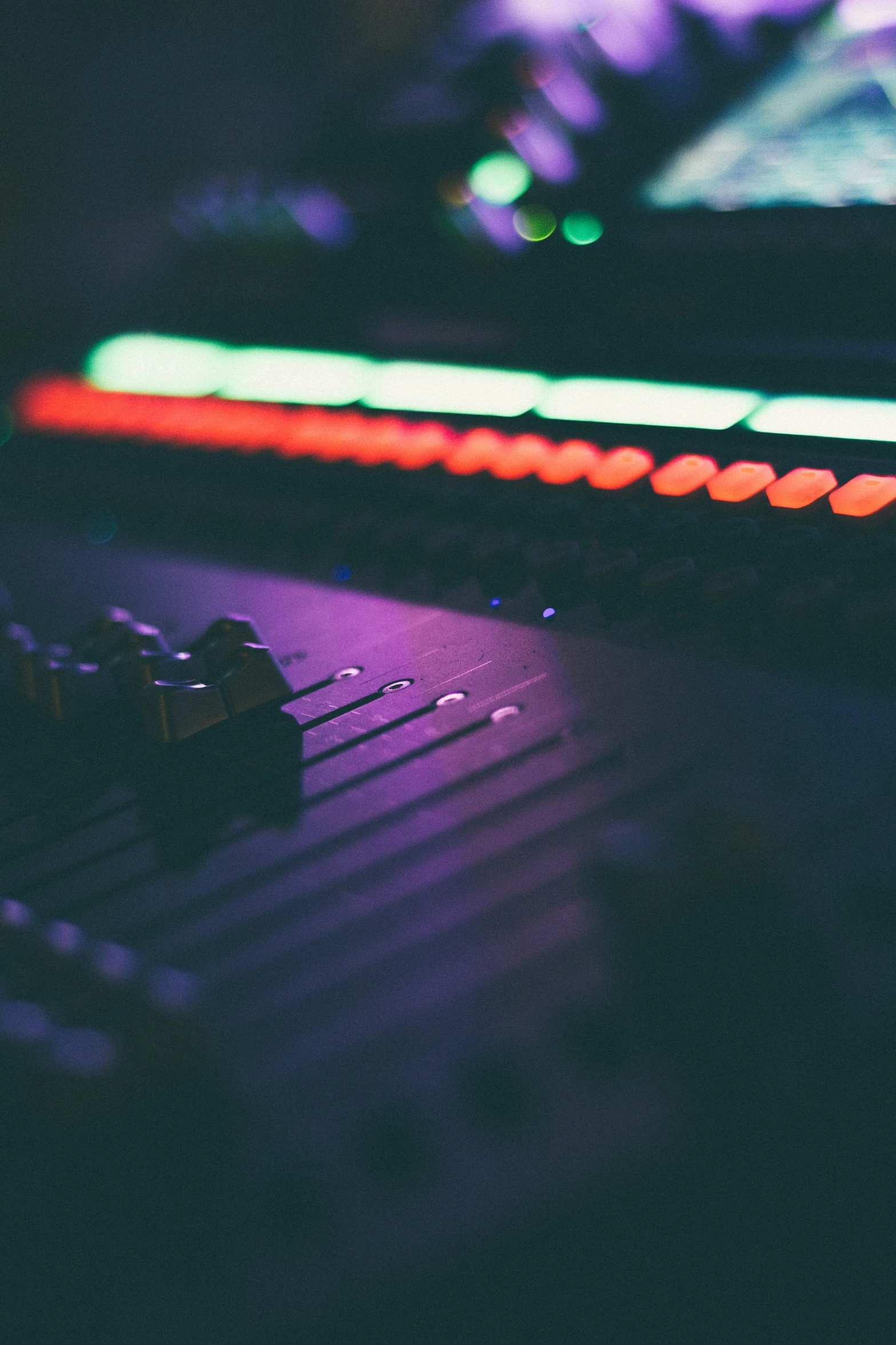 an analog piano mixing board in the dark