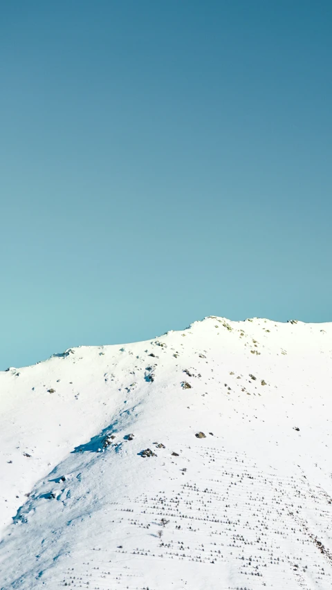 a ski lift stands tall above a snowy slope