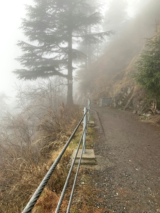 a foggy trail is going down the mountain