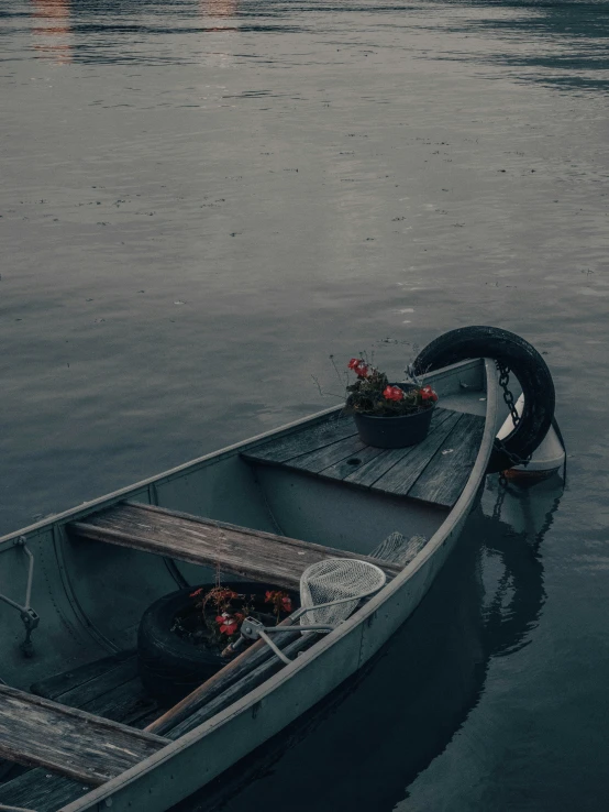 a boat sitting in the water in the rain