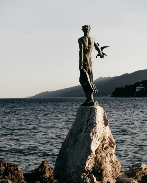 the statue has been placed on top of the rock