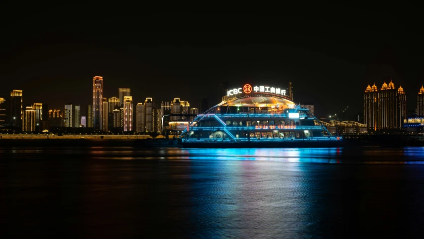 a cruise ship is lit up on the river