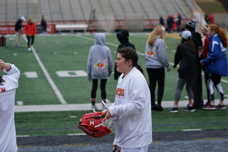 people standing and walking around a field with the goalies