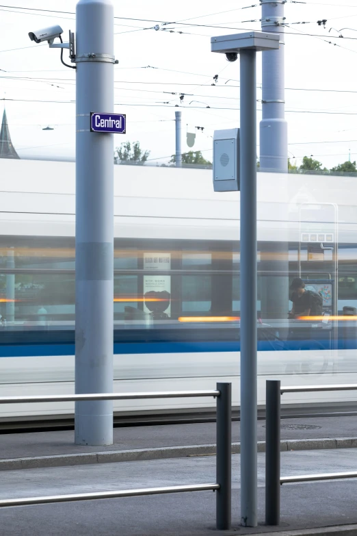 a train is driving by some poles