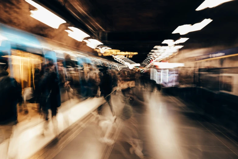 a blurry pograph of people on a train platform